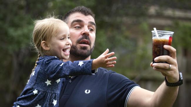 Harry Potter keeps his frozen Coke out of arm’s reach of daughter Ivy. Picture: Sarah Matray