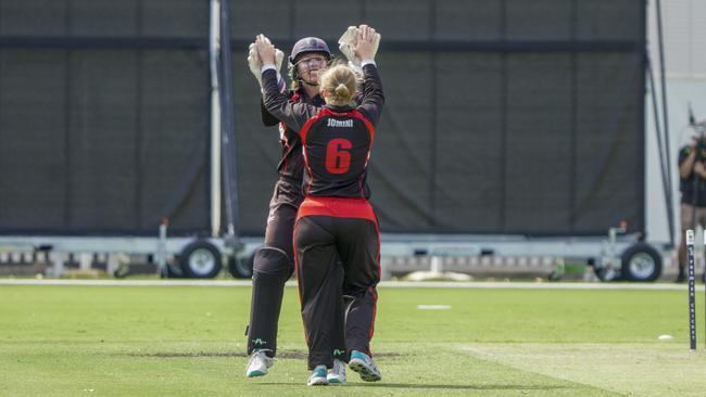 Katia Jomini and Tai Davidge celebrate a wicket for Essendon Maribyrnong Park. Picture: Valeriu Campan