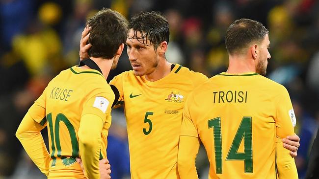 Robbie Kruse, Mark Milligan and James Triosi of Australia