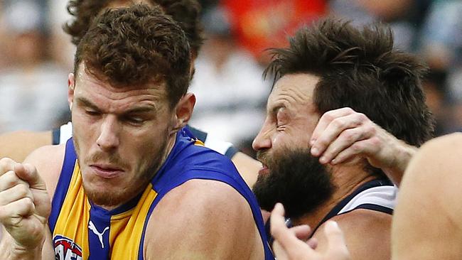 West Coast's Luke Shuey tried to elude Jimmy’s tackle, but also his beard which is starting to give opponents a rash when he gets too close. Picture: Colleen Petch