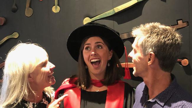 A long road to a PhD. The author at her graduation with her proud parents.