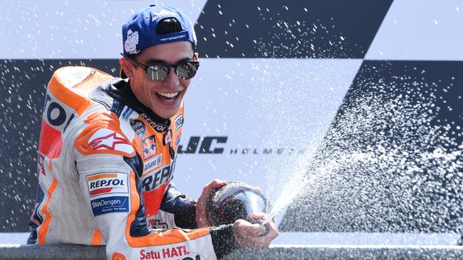 TOPSHOT - Winner Repsol Honda Team's Spanish rider Marc Marquez celebrates on the podium after the MotoGP race of the French motorcycling Grand Prix on May 20, 2018, in Le Mans, northwestern France.  / AFP PHOTO / Jean-Francois MONIER