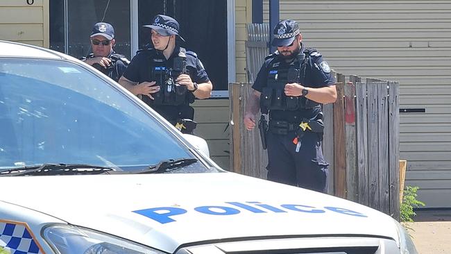 Police are on the scene at a Garbutt residence after a woman had her arm severed by a dog .