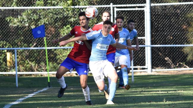 Jordan Kizi (right) looking to win the ball for Wollongong Olympic. Picture: Kiah Hufton