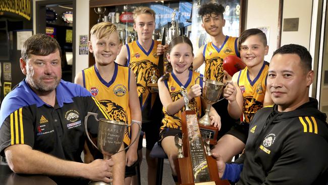 Salisbury West Football Club wants to return to the Adelaide Footy League after it was kicked out last year. New president Matthew Bates (left) and integrity officer Anthony Brennan (right) Callum, Caleb, Ella, Barialai and Lachlan. Picture: Dean Martin