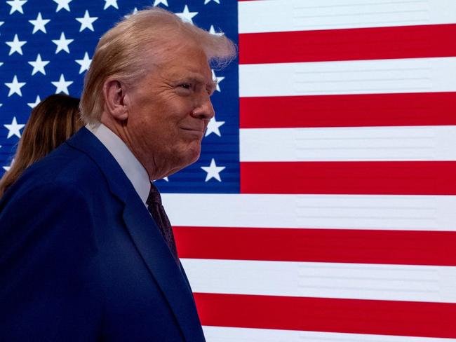 NEW YORK, NEW YORK - DECEMBER 12: President-elect Donald Trump walks onto the floor of the New York Stock Exchange (NYSE) with his wife Melania after being named TIMEâs âPerson of the Yearâ for the second time on December 12, 2024 in New York City. Trump followed a reception by ringing the opening bell on the trading floor.   Spencer Platt/Getty Images/AFP (Photo by SPENCER PLATT / GETTY IMAGES NORTH AMERICA / Getty Images via AFP)