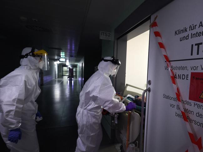 Medical personnel wear PPE as they transport a Covid-19 patient connected to an artificial heart-lung device at the University Medical Center Magdeburg in eastern Germany. Picture: AFP