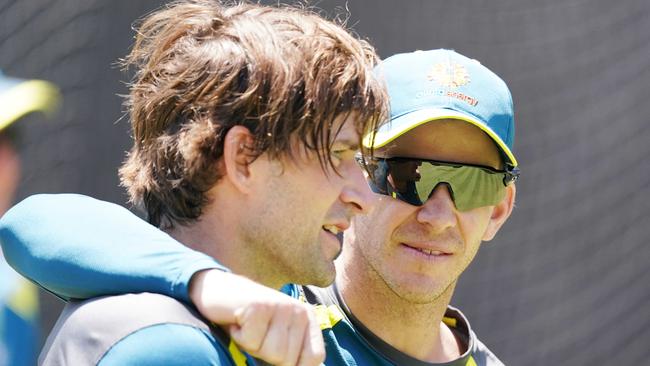 Tim Paine (right) chats with Joe Burns during the pair’s time together in the Australian team. Picture: AAP / Michael Dodge