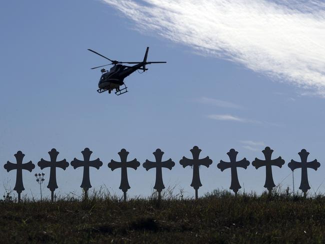 A law enforcement helicopter flies over crosses placed near the scene of a shooting at the First Baptist Church. Picture: AP