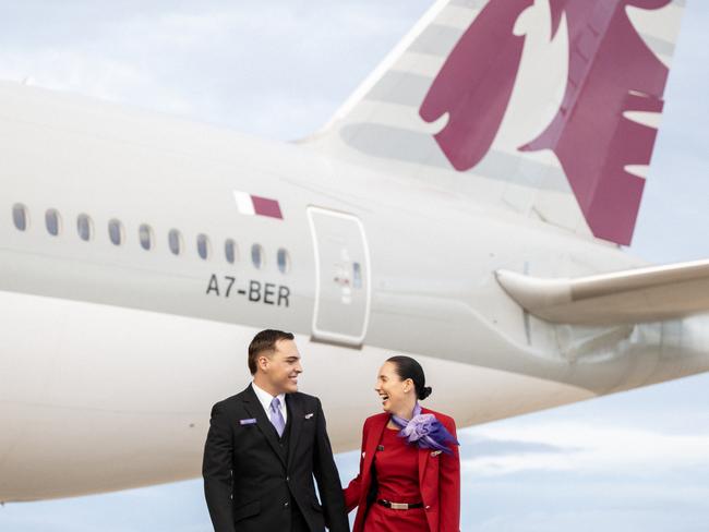 BRISBANE, AUSTRALIA - DECEMBER 04: In this image released on December 12, crew from Virgin Australia stand beside a Qatar Airways Boeing 777 at Brisbane Airport on December 04, 2024 in Brisbane, Australia. A new partnership between the two airlines has been launched which will deliver more value and choice to Australians, providing opportunities to travel to over 100 destinations across Europe, the Middle East and Africa. From December 12, Aussies can book Virgin Australia's new direct services from Sydney, Brisbane and Perth to Doha for travel from June 2025, with Melbourne set to launch later in 2025. These flights will be operated by Virgin Australia using Qatar Airways' spacious Boeing 777s, renowned for their Qsuite Business Class. (Photo by James D. Morgan/Getty Images for Virgin Australia)