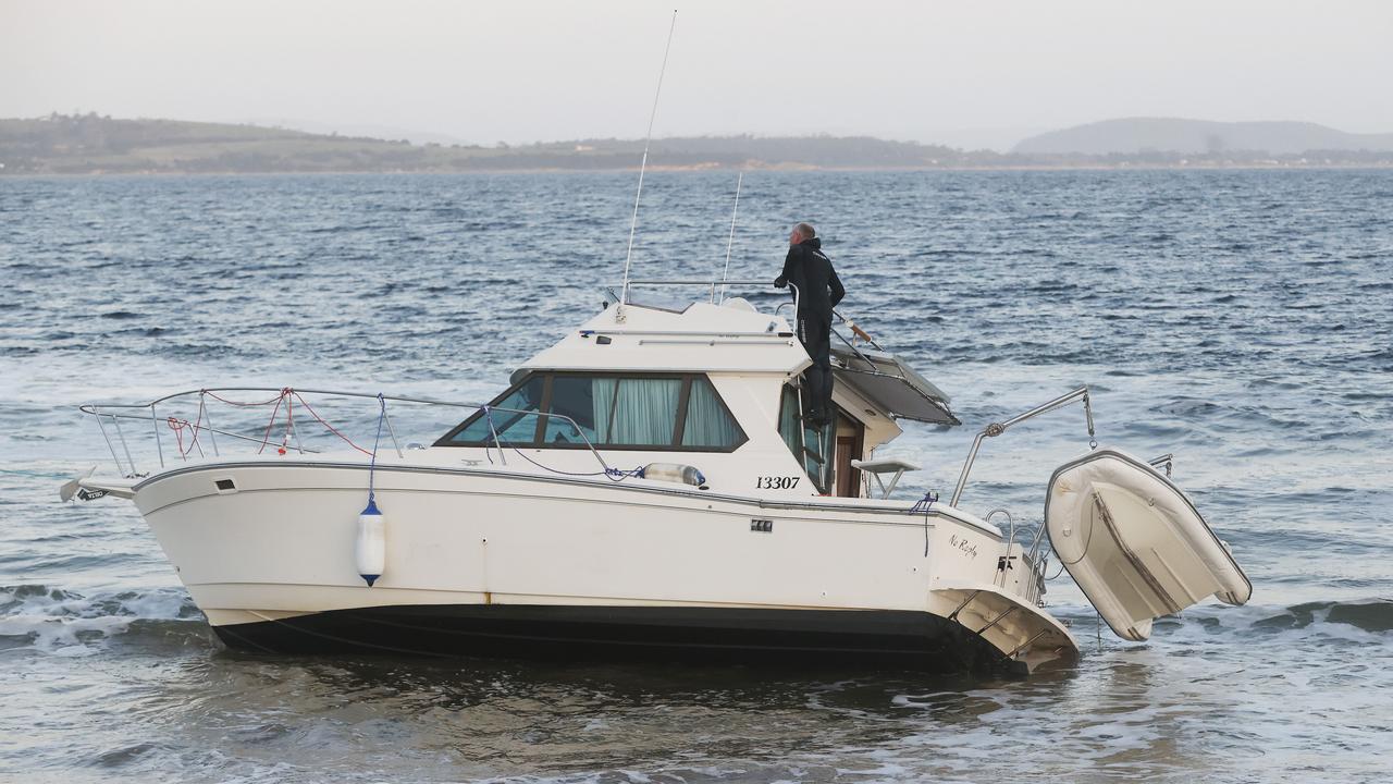 Police investigate after a boat washed up on Kingston Beach with no one on board. Picture: Nikki Davis-Jones