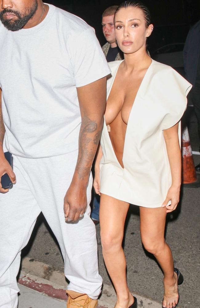Bianca Censori continues to steal the show from husband Kanye West with her daring fashion choices, this time it was a micro mini dress with a plunging neckline that showed off her skin from neck to navel, with glimpses of fashion tape. Picture: HEDO / BACKGRID