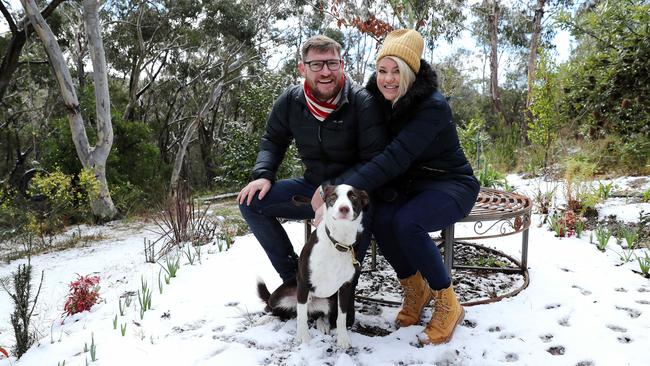 Chris and Anna with their dog Whiskey in the snow at Blackheath. Picture: Tim Hunter