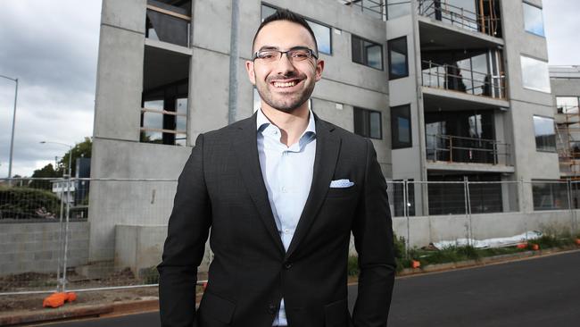 Hobart City Council Alderman Simon Behrakis standing in front of a new multi-residential development in Sandy Bay. Picture: LUKE BOWDEN