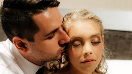 Jason Hale kisses his new bride Ashleigh after their wedding at Sea World Resort on September 5