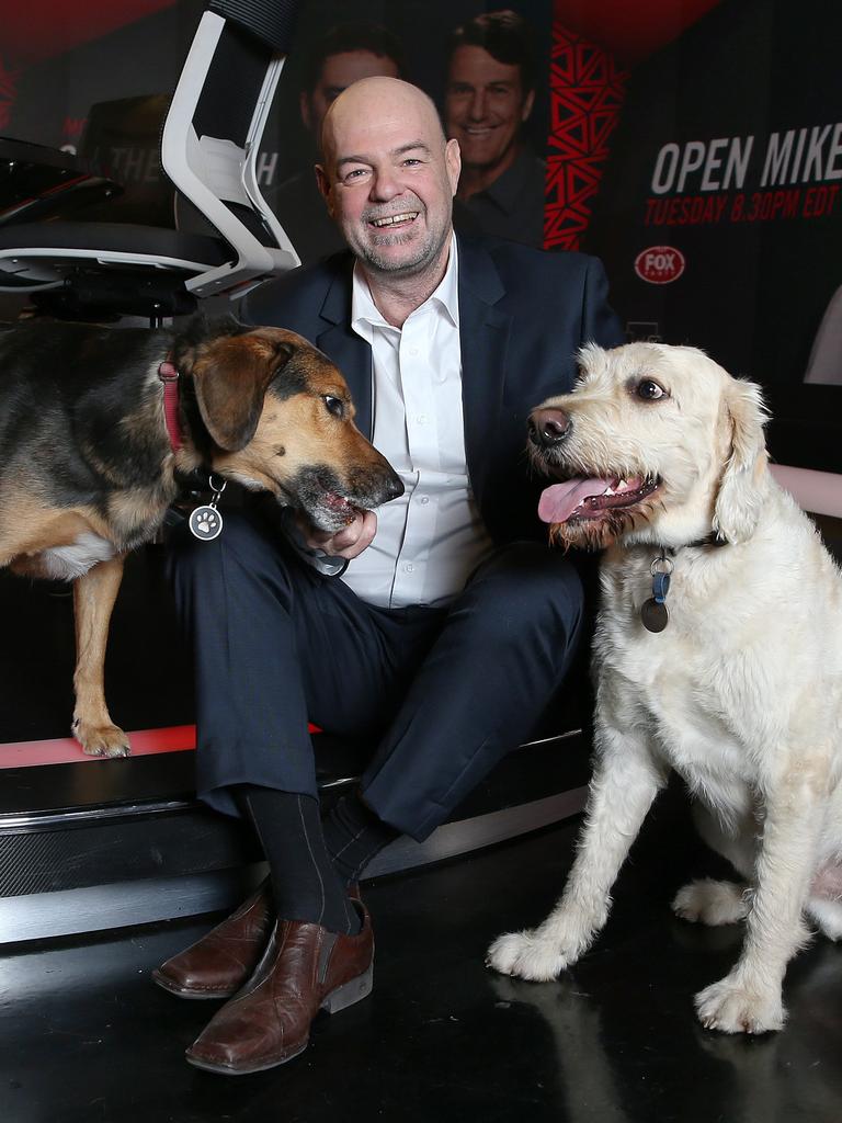 Mark Robinson with his beloved dogs at Fox Footy. Picture: Michael Klein