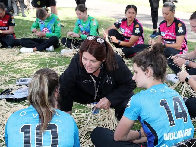 Haylee Markham, who is a Kuma Kaaru cultural facilitator, helps WBBL players with basketweaving during the WBBL First Nations Round Launch in Adelaide on Monday. Picture: GETTY