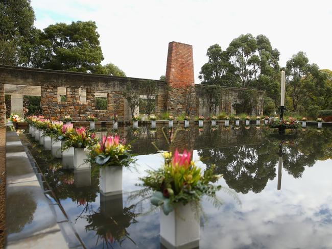 Family and community members lay 35 floral tributes in the Memorial Pool to remeber the victims during the 20th anniversary commemoration service of the Port Arthur massacre on April 28, 2016 in Port Arthur, Australia. Picture: Robert Cianflone/Getty