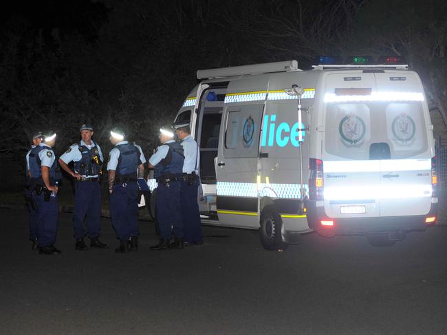 Police at the murder scene last night. Picture: Simon Bullard