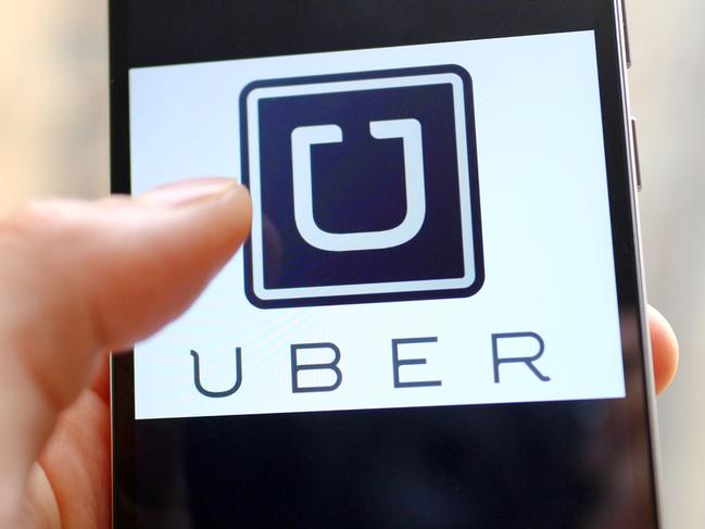 --FILE--A mobile phone user shows the logo of car-hailing app Uber on his smartphone in Chengdu city, southwest China's Sichuan province, 6 May 2015. U.S. firm Uber Technologies Inc and Chinese rival Didi Kuaidi are taking steps to operate legally in China, a key market for both firms but where their car hailing services currently operate in a regulatory prey zone. Uber China said in a statement on Thursday (8 October 2015) it was "actively preparing" documents to apply for a license to operate an online car-hailing platform to meet new regulations governing the sector that are expected to be announced soon. Didi Kuaidi, a $16 billion valued firm backed by Chinese Internet giants Alibaba Group Holding Ltd and Tencent Holdings Ltd, also said on Thursday it had received a car booking license for its operations in Shanghai and that it was seeking more licenses from other cities.
