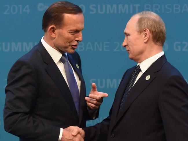 A combination of pictures of Australian Prime minister Tony Abbott (left) greeting Russian President Vladimir Putin during the official welcome at the Brisbane Convention and Exhibitions Centre (BCEC) in Brisbane, Saturday, Nov. 15, 2014. World economic leaders are in Brisbane to attend the G20 Leadership Summit on November 15-16. (AAP Image/Lukas Coch) NO ARCHIVING