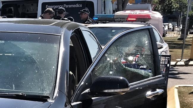 Police smash the window of a car to rescue a child. 