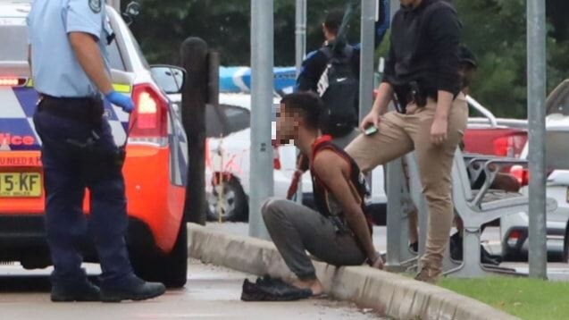 A man is arrested at the grounds of Coffs Harbour hospital on March 19.