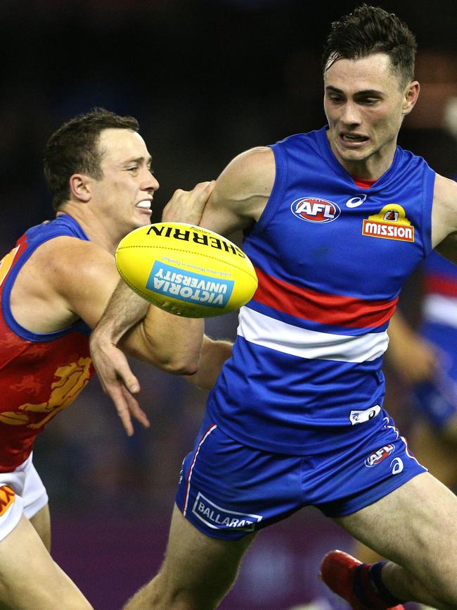 Toby McLean beats Brisbane’s Lewis Taylor to the ball. Picture: AAP Image/Hamish Blair