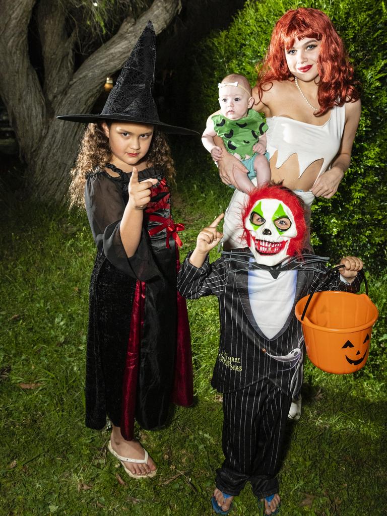 Dressed to trick or treat are (from left) Faith Patia, Zyrell Thurston and Maddison Vane holding baby Adalyn Siebuhr on Halloween, Monday, October 31, 2022. Picture: Kevin Farmer