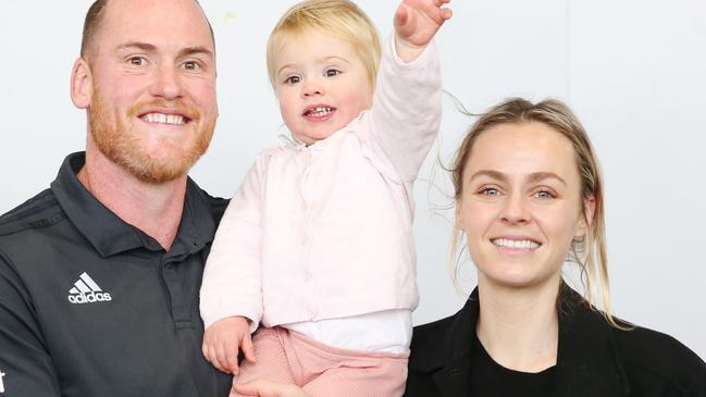 Hawthorn footballer Jarryd Roughead with daughter Pip and wife Sarah during his retirement press conference last year. Picture: AAP Image/Michael Dodge