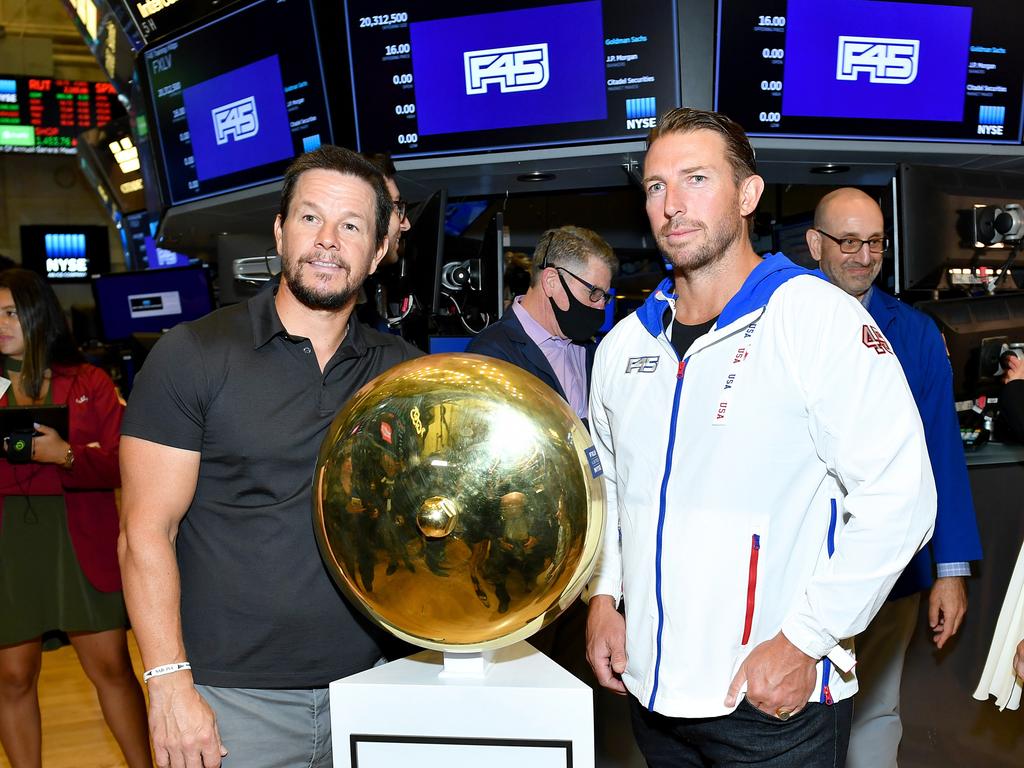 Mark Wahlberg (L) and F45 Founder and CEO Adam Gilchrist pose on the trading floor as F45 Training rings the opening bell at the New York Stock Exchange on July 15, 2021 in New York City. (Photo by Noam Galai/Getty Images for F45 Training)