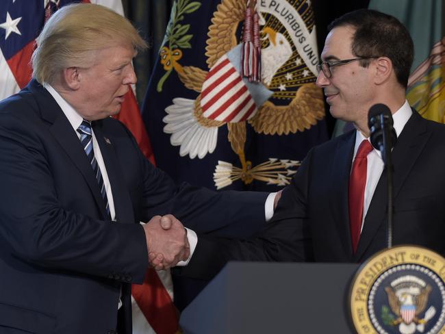 US President Donald Trump shakes hands with Treasury Secretary Steven Mnuchin.  Picture:  AP