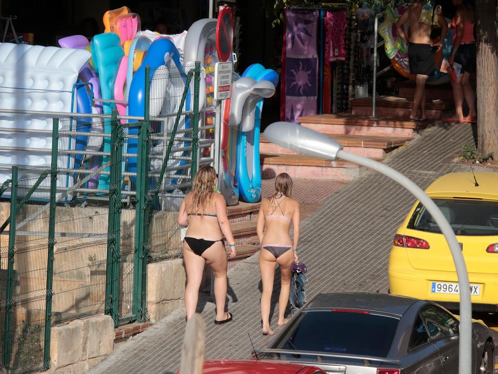 Tourists walking along the famous Punta Ballena street, in the beach of Magaluf, in their bikinis. Picture: Alamy