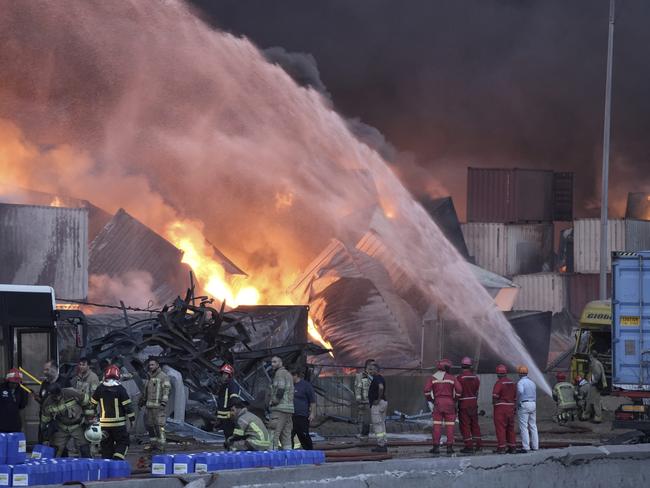 Firefighters try to extinguish the fire, Sunday, April 27, 2025, after a massive explosion and fire rocked a port near the southern port city of Bandar Abbas, Iran, on Saturday. (Mahdi Nori/Fars News Agency via AP)