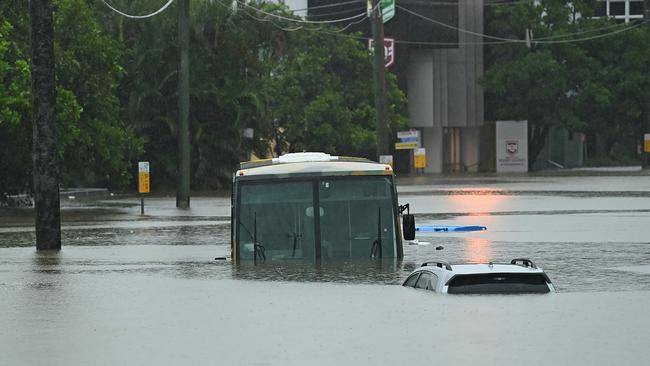 Cars and a bus submerged next to Suncorp stadium, in Milton, on Sunday. Picture: Lyndon Mechielsen