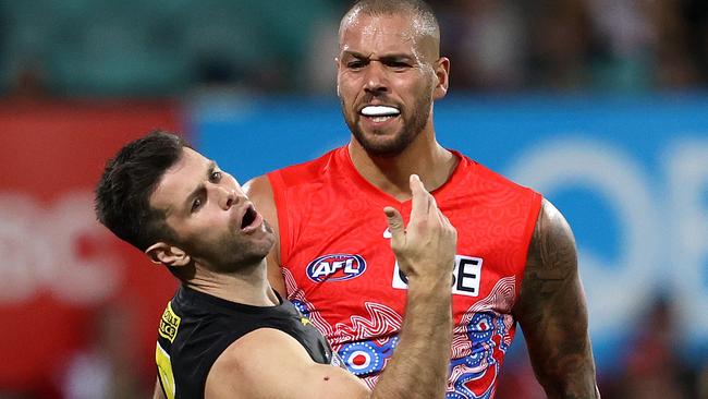 Trent Cotchin reacts after being struck.