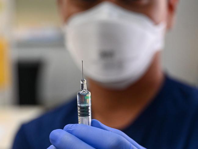 A nurse prepares a dose of the Sinopham Covid-19 coronavirus vaccine at the Mount Elizabeth hospital vaccine centre in Singapore on September 7, 2021. (Photo by Roslan Rahman / AFP)