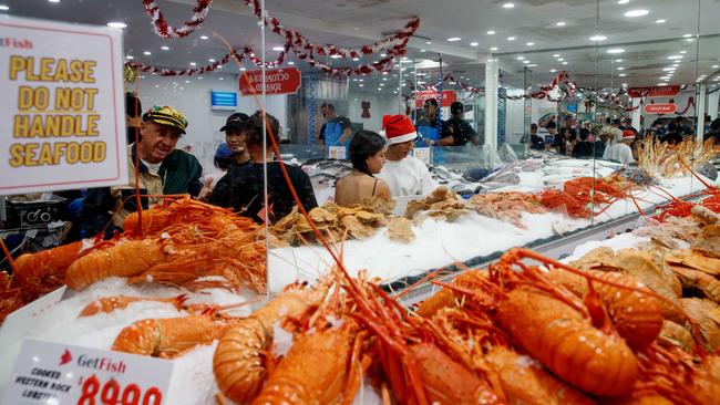 SYDNEY, AUSTRALIA - NewsWire Photos DECEMBER 24, 2024: People queue for seafood at the Sydney Fish Market in Pyrmont on Christmas Eve. Picture: NewsWire / Nikki Short