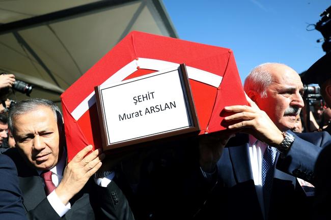 The coffin of Murat Arslan, the taxi driver killed in Wednesday's attack, was carried by Interior Minister Ali Yerlikaya, left, and parliamentary speaker Numan Kurtulmus