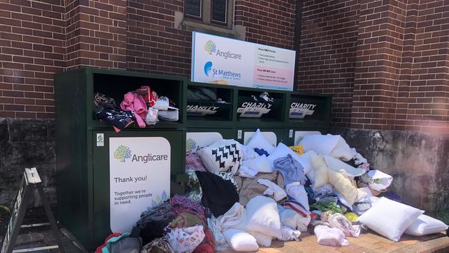 Charity bins overflowing outside St Matthews Church in Manly earlier this week.