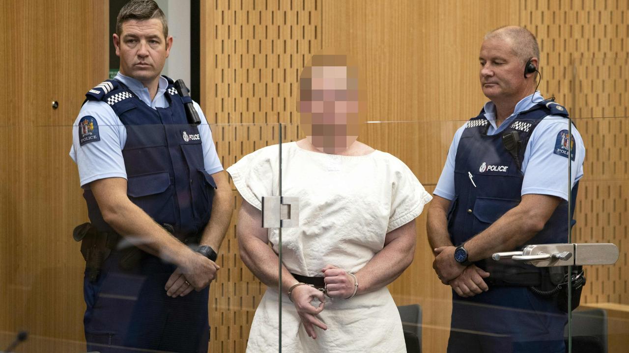 Brenton Tarrant, the man charged in relation to the Christchurch massacre, makes a sign to the camera during his appearance in the Christchurch District Court Picture: Mark Mitchell / AFP