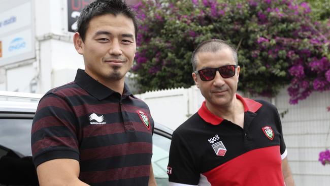 Ayumu Goromaru shakes hands with Toulon owner Mourad Boudjellal before a press conference.