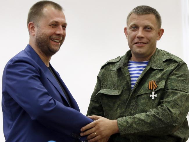 Outgoing Prime Minister Alexander Borodai, left, shakes hands with Alexander Zakharchenko, who has been put forward as the new Prime Minister of the self-declared "Donetsk People’s Republic". Picture: Sergei Grits