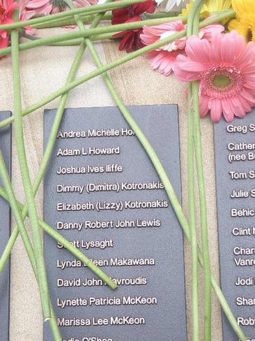 Flowers on the Bali bombing victims memorial at Coogee, with the names of Maria’s two sisters (centre).