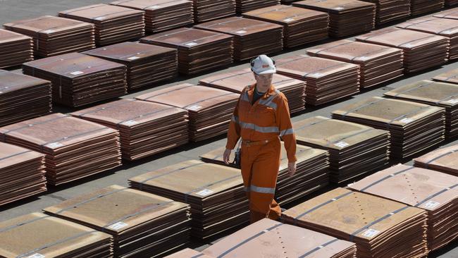 Kelly McPhee, superintendent production labs walks past copper sheets at Olympic Dam. Picture: Brett Hartwig