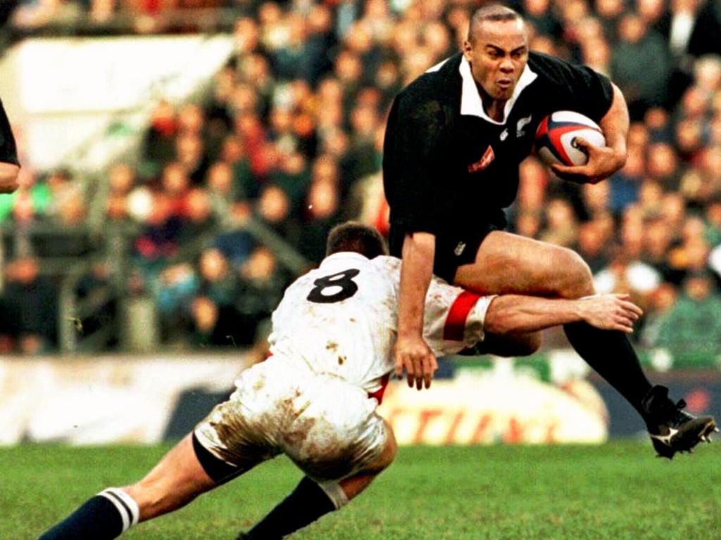 Jonah Lomu leaps over an attempted tackle by England’s Richard Hill.