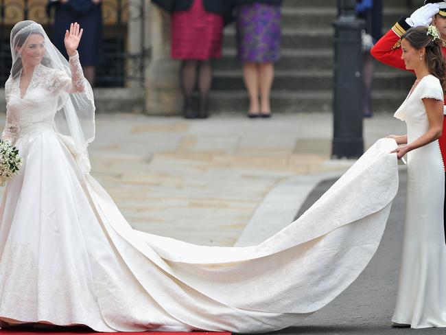 Pippa Middleton holds her sister’s dress before walking in to the Abbey to attend the Royal Wedding of Prince William to Catherine Middleton at Westminster Abbey on April 29, 2011. Picture: Getty.