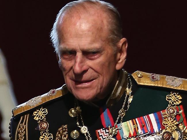 LONDON, ENGLAND - MAY 08:  Queen Elizabeth II, and Prince Phillip, Duke of Edinburgh are escorted through the Norman Porch of the Palace of Westminster after the State Opening of Parliament on May 8, 2013 in London, England. Queen Elizabeth II unveiled the coalition government's legislative programme in a speech delivered to Members of Parliament and Peers in The House of Lords. Proposed legislation is expected to be introduced on toughening immigration regulations, capping social care costs in England and setting a single state pension rate of 144 GBP per week.  (Photo by Dan Kitwood - WPA Pool/Getty Images)