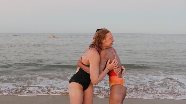 Marathon swimmers Harriet Grant and Kaname Woodfield on the beach at Yorkeys Knob after swimming from Green Island to the mainland on Saturday. Picture: Nicole Gibson