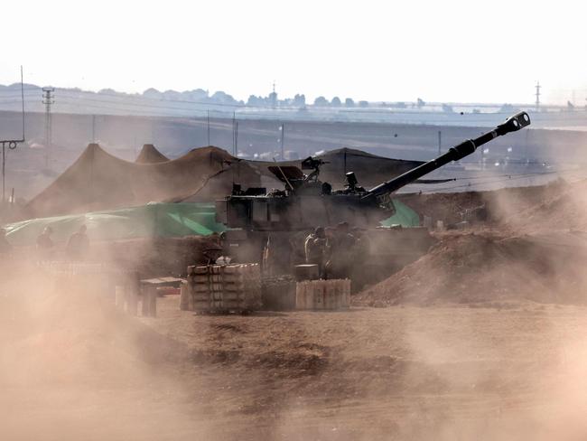 An Israeli artillery crew prepare to fire from a field near the Israeli city of Sderot toward the Gaza Strip. Picture: AFP